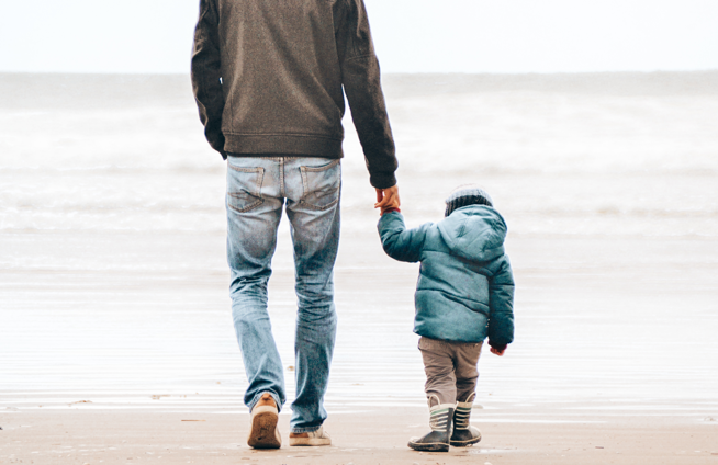 FamilyLaw Child Holding Father's hand walking on beach